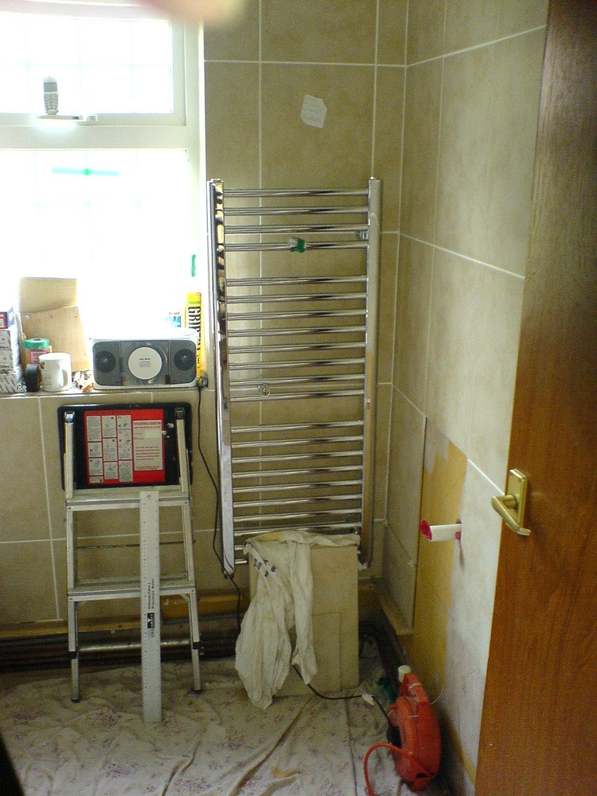 In preparation: tiling complete, sink waste and towel radiator fitted.