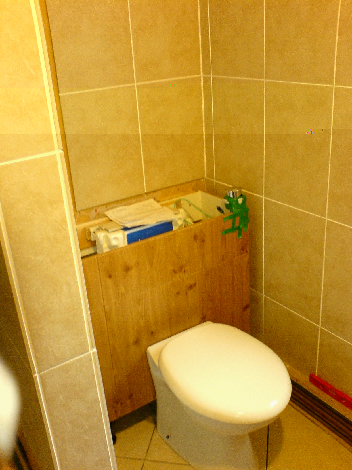 The loo cistern is a compact concealed type, in a unit.