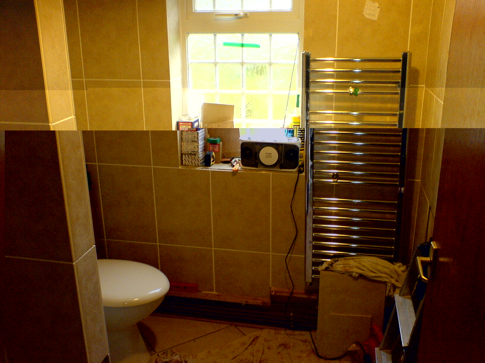 The loo is installed and the side wall of the shower area has been built and tiled.